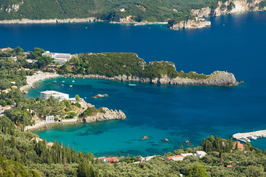 Corfu yacht charter Turquoise bay in Corfu island with crystal clear water and green coastline Greece