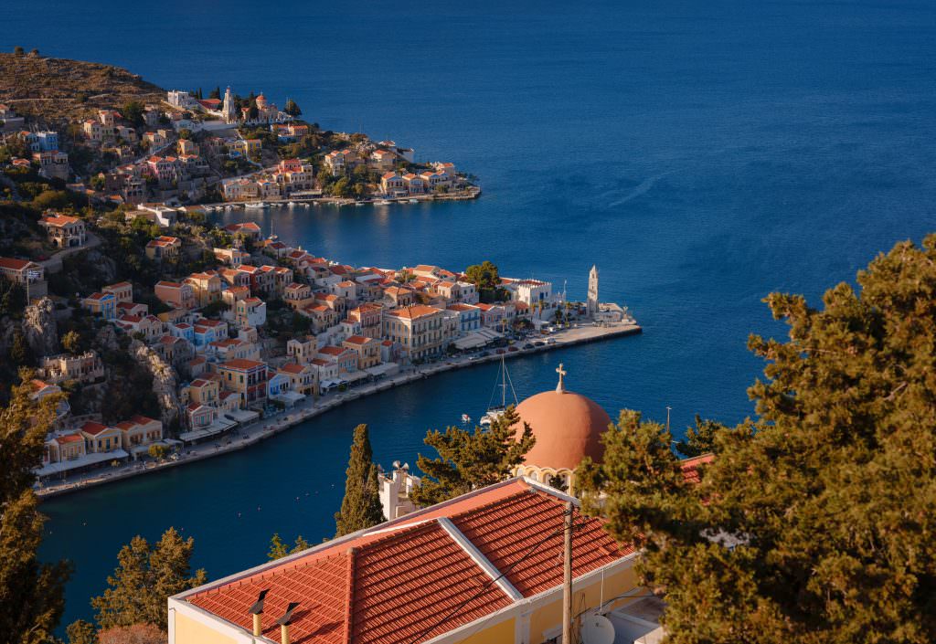 Symi harbour panoramic night view with colorful houses and yachts Greece