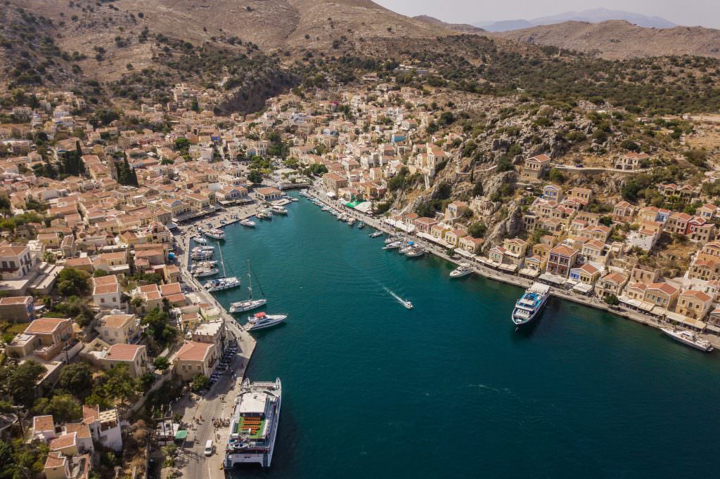 Symi Island Gialos harbour aerial view colorful houses and yachts Greece