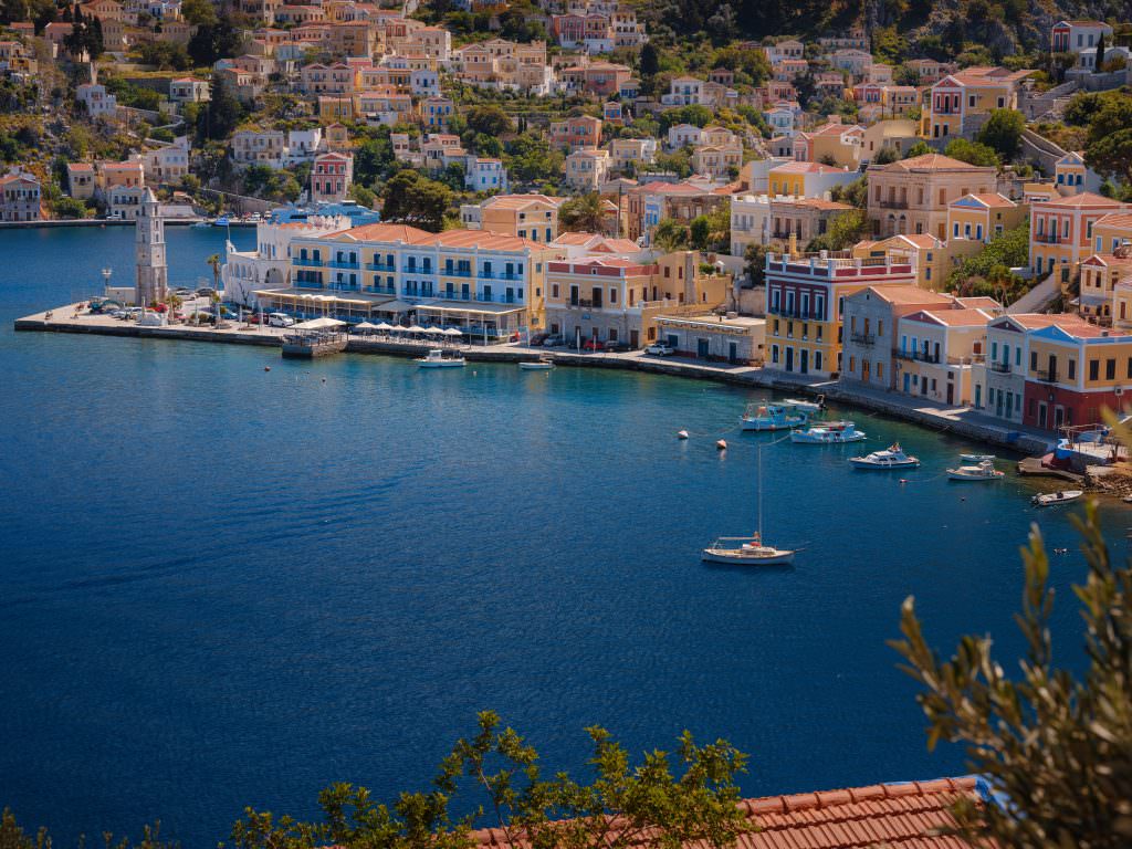 Symi Island Gialos harbour waterfront with colorful neoclassical houses Greece