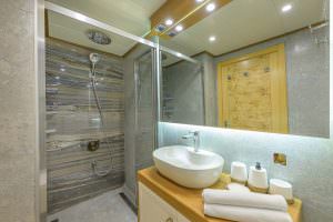 Belgin Sultan yacht bathroom with modern shower cabin, elegant marble design and luxury yacht interior details