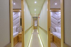 Belgin Sultan yacht interior corridor with modern lighting and guest cabins, luxury yacht accommodation layout