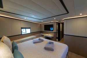 Calm Down luxury yacht charter spacious guest cabin with double bed TV and modern ensuite layout