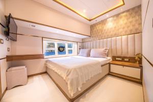 Floki luxury yacht charter VIP cabin with double bed, elegant interior design and sea view window