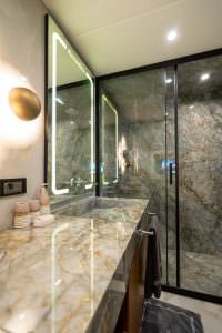 North Wind motor sailer bathroom, luxury yacht interior with marble design, modern shower cabin and elegant illuminated mirror