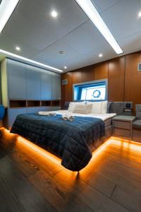 North Wind motor sailer cabin with ambient lighting, luxury yacht interior featuring modern bedroom design and elegant illuminated details
