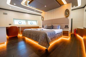 North Wind motor sailer master cabin wide angle, luxury yacht interior with modern design, ambient lighting and spacious elegant layout
