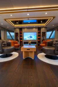 North Wind motor sailer salon, luxury yacht interior with designer seating area, ambient lighting, and elegant entertainment setup