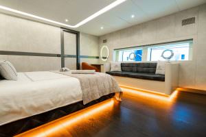 North Wind motor sailer VIP cabin modern view, luxury yacht guest suite with spacious seating area, elegant lighting and contemporary interior design