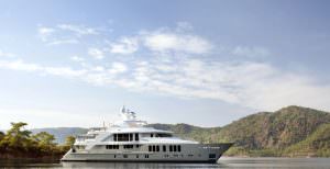 ORIENT STAR yacht charter anchored in calm bay with mountain landscape