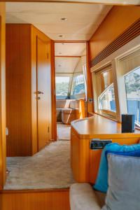 Reis yacht interior corridor with sea view windows and modern design, luxury yacht charter experience