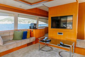 Reis yacht lounge interior with panoramic sea view and modern design, luxury yacht charter experience