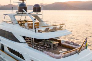 Luxury yacht Takara One aft deck lounge with seating area and sunset sea view