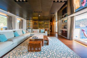 Luxury yacht Takara One main salon seating area with modern design, large windows and sea view